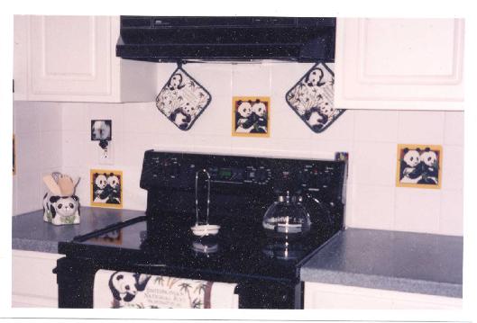 PANDA TILES INSERTED IN A WHITE KITCHEN BACKSPLASH